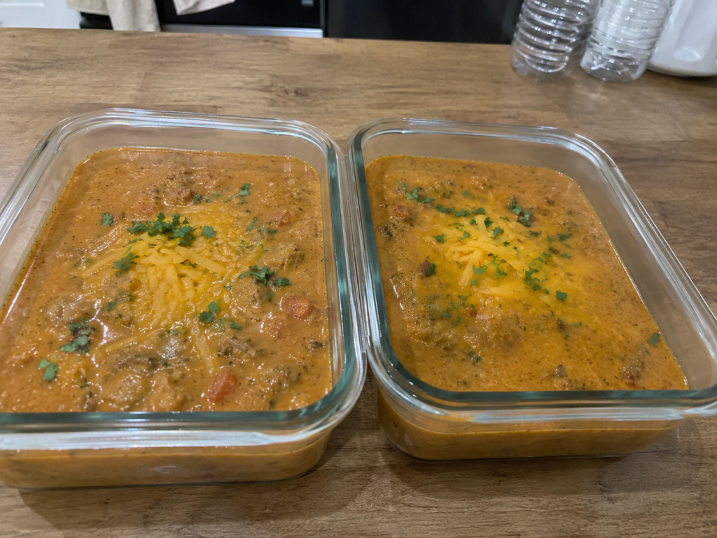 Keto taco soup stored in glass meal prep containers for the week.